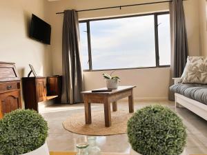 a living room with a table and a couch at Olive Grove Addo in Addo