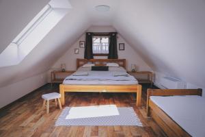 a bedroom with a bed in a attic at Pod Buchtou in Daňkovice