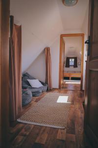 an attic room with a mirror and a bedroom at Pod Buchtou in Daňkovice