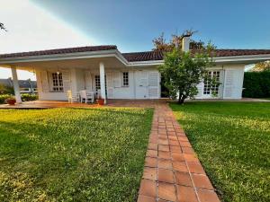 a house with a brick path in front of it at Casa Sierrapando - by Wehomes in Torrelavega