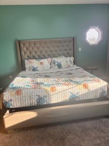 a bed with a quilt and pillows in a bedroom at Sand Dollar Motel in Atlantic Beach