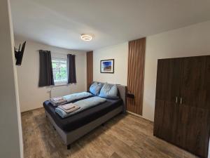 a living room with a couch and a cabinet at Ferienwohnungen Forever in Gamlitz +16 photos