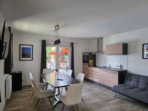 a kitchen and dining room with a table and chairs at Ferienwohnungen Forever in Gamlitz