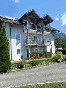 a large white house with balconies on a street at Appartment Isabelle Home in Hermagor +36 photos