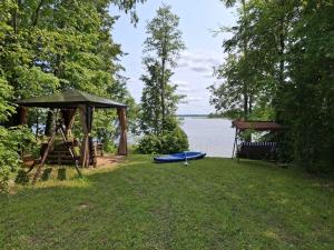 a picnic area with a gazebo and a bench at Camping "Sīvezers" in Auleja