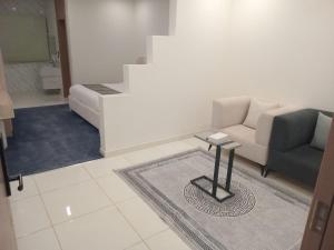 a living room with a couch and a table at فيلمست ريزيدنس ابهاVelmist Residence Abha in Abha