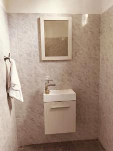 a bathroom with a white sink and a mirror at Casa Imox in Bacalar