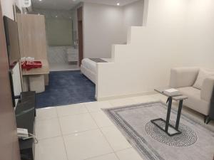 a living room with a couch and a table at فيلمست ريزيدنس ابهاVelmist Residence Abha in Abha