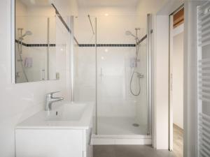 a white bathroom with a shower and a sink at Aparthouse HAAS41 - Eupen in Eupen +51 photos