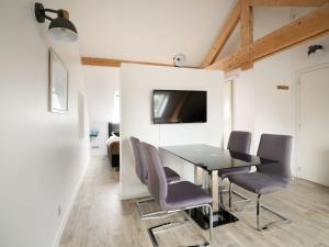 a dining room with a table and chairs at Aparthouse HAAS41 - Eupen in Eupen