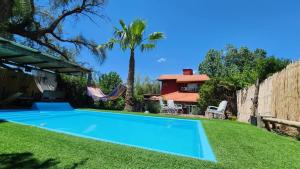 a swimming pool in the yard of a house at Lodi House in Godoy Cruz