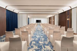 a conference room with white chairs and a screen at TUI BLUE Han River in Danang +45 photos