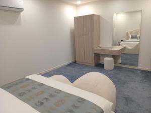 a bedroom with a bed and a sink and a mirror at فيلمست ريزيدنس ابهاVelmist Residence Abha in Abha