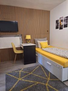 a bedroom with a bed with a desk and a chair at Eurovelo6 Stop in Solt