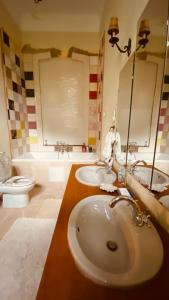 a bathroom with a sink and two toilets at Rózsilak in Balatonfüred +56 photos
