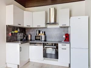 a white kitchen with white cabinets and appliances at EM LIFE COLMAR in Colmar