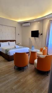 a bedroom with a bed and a table and chairs at Bustani Tulivu in Bungoma +10 photos