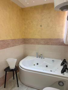 a bathroom with a white bath tub in a room at Maison D'orleans By Catalano in Palermo