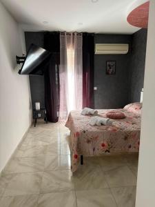 a bedroom with a bed and a window at Maison D'orleans By Catalano in Palermo +2 photos
