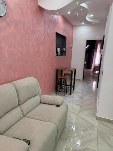 a living room with a couch and a table at Maison D'orleans By Catalano in Palermo
