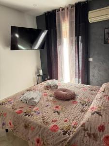 a bedroom with a bed with a floral bedspread at Maison D'orleans By Catalano in Palermo