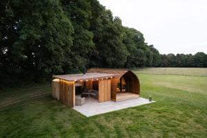 a small wooden building in the middle of a field at Bainton Burrows by Wigwam Holidays in Great Driffield
