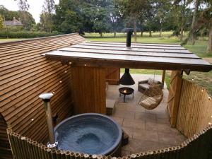a gazebo with a hot tub on a patio at Bainton Burrows by Wigwam Holidays in Great Driffield