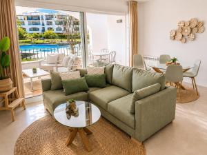 a living room with a couch and a table at Casa Lilo - Renovated 2-Bed Apartment with Pool View - La Torre Golf Resort in Torre-Pacheco