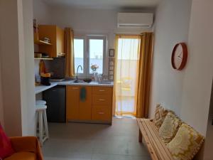 a kitchen with a sink and a counter top at Cosy Stay in Platamonas +4 photos