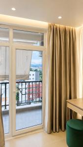 a room with a window with a view of a building at Oryn Suites in Tirana
