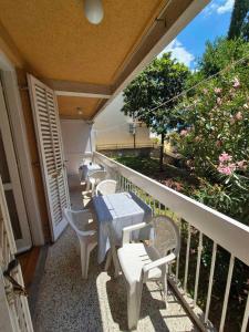 a patio with tables and chairs on a balcony at Drača in Savina