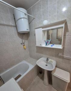 a bathroom with a sink and a toilet and a tub at Drača in Savina +9 photos