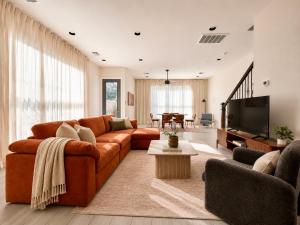 a living room with a couch and a television at Houston House Downtown Stays - Free Parking in Houston