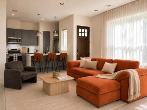 a living room with a couch and chairs and a kitchen at Houston House Downtown Stays - Free Parking in Houston