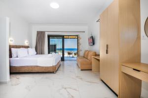 a hotel room with a bed and a couch at Summer & Sun in Vathí +98 photos