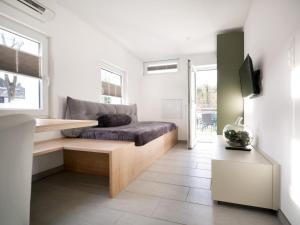 a room with a bed and a tv in it at Aparthouse HAAS41 - Eupen in Eupen