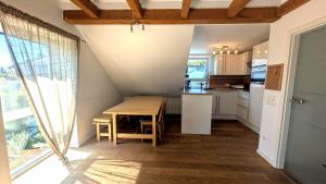 a small kitchen with a wooden table and a table at Ferienwohnung Malbrich in Gräfenberg