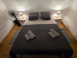 a bedroom with a large bed with two pillows at DenVigo in Čakovec