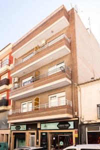 an apartment building with a balcony on top of it at Viceda Home in Yecla