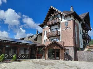a large brick building with balconies on it at Villa Alpina Borsec in Borsec