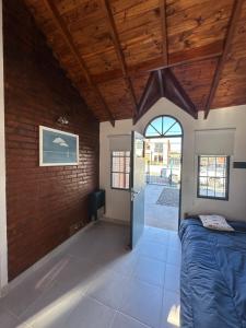 a bedroom with a bed and a wooden ceiling at Solymar Alojamiento in Puerto Madryn