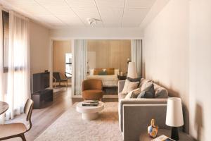 a living room with a couch and a bedroom at C211 Barcelona - Simaba Group in Barcelona