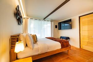 a bedroom with a bed and a large window at Esensia Boutique Studio in Oranjestad