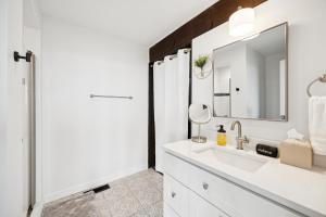 a white bathroom with a sink and a mirror at Luxe Mt Adams Lookout in Cincinnati +104 photos