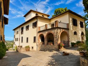 a house with a dog sitting in front of it at Podere di Montecchio in Florence