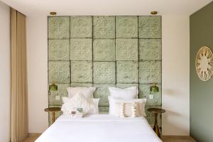 a bedroom with a white bed and a green wall at Résidence Casarina in Bonifacio +68 photos