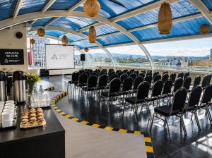 a conference room with chairs and a screen in a building at Zen Hotel Boutique in Bogotá