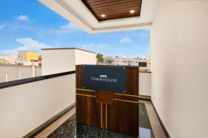 a sign that says top townhouse on a balcony at Hotel O R Eleven in Hyderabad