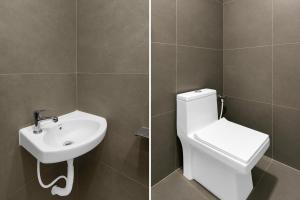 a bathroom with a toilet and a sink at Hotel O R Eleven in Hyderabad +50 photos