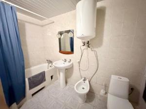 a bathroom with a sink and a toilet and a shower at Готель на Шнеєрсона in Dnipro